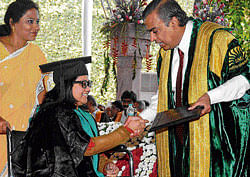 Rachita Rasiwava, a physically challenged student, receives the certificate from Mukesh Ambani at the 38th annual convocation of the Indian Institute of Management, Bangalore on Monday. DH&#8200;Photo