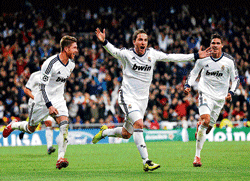 killer blow: Real Madrids Gonzalo Higuain (centre) celebrates after scoring his teams third goal on Wednesday. AP