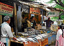 Unkept promise:  Vendors from Cox Town Market have been forced to sell their wares on the pavement. DH Photo