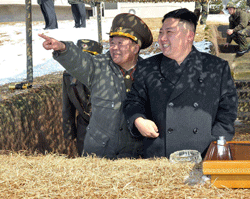 This picture taken by North Korea's official Korean Central News Agency on March 20, 2013 shows North Korean leader Kim Jong-Un (C) inspecting a live fire drill using self-propelled drones at an undisclosed location in North Korea. Much like his father Kim Jong-Il, North Korea's new young leader Kim Jong-Un is viewed by much of the outside world with a heady mix of incomprehension, ridicule and fear. AFP PHOTO