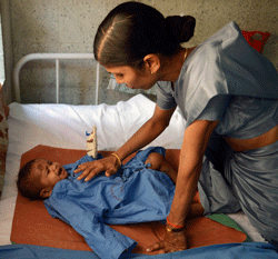 An unidentified child around ten months old, that survived a building collapse, recovers at a hospital in Thane, on the outskirts of Mumbai on April 5, 2013. At least 38 people were crushed to death on the outskirts of Mumbai after an unauthorised partly-built apartment block collapsed, police said Friday, highlighting the dangers of India's illegal housing boom. AFP PHOTO
