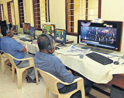 Local channels are being monitored 24x7 by staff deputed on special duty at Information Office in Mangalore on Sunday. DH photo