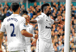Jubilant: Tottenham Hotspurs Emmanuel Adebayor (right) celebrates with his team-mates after scoring on Sunday. AP
