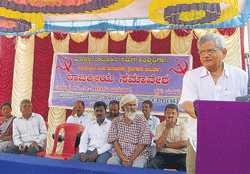 CPM leader Seetharam Yechury speaks at a party convention held at Malavalli, on Sunday. CPM district leaders G Ramakrishna, MLA candidate K Basavaraju and G N Nagaraj are seen. DH PHOTO