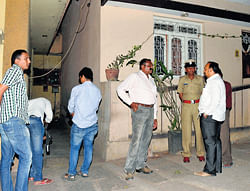 Police inspect the spot where Manjunath (inset), a real estate agent, was murdered in Chamarajpet on Monday. DH Photo