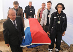 Rodolfo Reyes (L), grandnephew of Chilean poet and Nobel laureate Pablo Neruda, carries his coffin covered with the Chilean flag, inside the grounds of his house-museum after the exhumation of his remains in the coastal town of Isla Negra. Reuters.