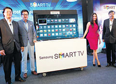 Samsung India Sr VP (Consumer Electronics) S K Kim (2nd from left) launches Samsung Smart TV in Bangalore. PTI