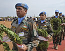 Indian United Nations (UN) peacekeepers hold wreathes of flowers on April 10, 2013 in Juba during a funeral ceremony for the five Indian peacekeepers killed during an ambush on April 9, in the troubled eastern region of Jonglei. Five peacekeepers and seven civilians were killed in an ambush by unidentified gunmen when a convoy of UNMISS vehicles was attacked near the settlement of Gumuruk. Four Kenyans, two South Sudanese working for the UN and a compatriot working alongside the Kenyans for a water drilling company were amongst the victims, the company said. The memorial ceremony was attended by India's Ambassador to South Sudan Parmod Bajaj, South Sudan deputy minister for International Cooperation Elias Nyamlel Wako and the Special Representative to the UN Secretary-General, Hilde F. Johnson. AFP PHOTO