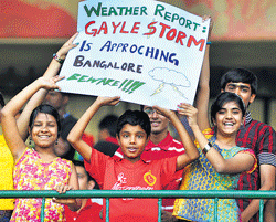 Vibrant: Many came with innovative posters to the match. dh photos by srikanta sharma R
