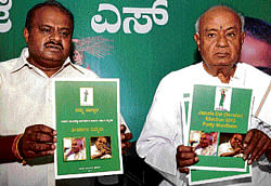 JD(S) National president H D Deve Gowda and its State  president H D Kumaraswamy release their party election manifesto in Bangalore on Saturday. DH photo
