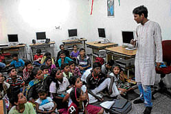 Sudhir, a member of Unnoticed giving mathematics lessons to poor children.