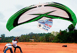 Excitement in air: Meghalaya Paragliders Association President Nikolai Singh battles with the strong wind while trying to fly his para-glider at Shridevi College Grounds on Monday. DH Photo
