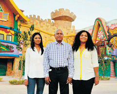 Manmohan Shetty (centre), with his daughters, at Adlabs Imagica in Khopoli on Monday. AFP