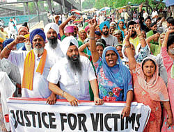 People protest outside Karkardooma Court  on Tuesday. DH