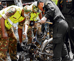 A team of National Security Guards collect evidence at the site of bomb blast just outside the BJP office. DH Photos