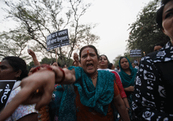 A supporter of Bharatiya Janata Party (BJP) shouts slogans during a candle light vigil in New Delhi April 20, 2013. Angry crowds demonstrated in capital on Saturday after a five-year-old girl was allegedly raped, tortured and kept in captivity for 40 hours, reviving memories of last December's brutal assault on a woman that shook the country. REUTERS