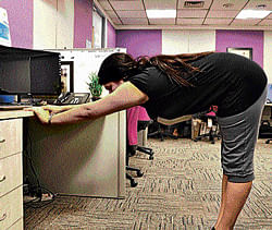 staying fit Some professionals try to incorporate desktop yoga into their daily schedules.