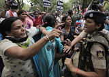 Women activists of India's main opposition Bharatiya Janata Party are stopped by police near the residence of ruling Congress party president Sonia Gandhi during a protest against the rape of a 5-year-old girl in New Delhi, India, Sunday, April 21, 2013. The girl was allegedly kidnapped, raped and tortured by a man and then left alone in a locked room in Indias capital for two days. (AP Photo