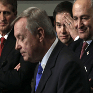 U.S. Sen. Richard Durbin (D-IL) (2nd L) speaks as (L-R) Sen. Jeff Flake (R-AZ), Sen. Marco Rubio (R-FL), and Sen. Chuck Schumer (D-NY) listen during a news conference on immigration reform April 18, 2013 on Capitol Hill in Washington, DC. The senators discussed the 'Border Security, Economic Opportunity, and Immigration Modernization Act'. Alex Wong/Getty Images/AFP