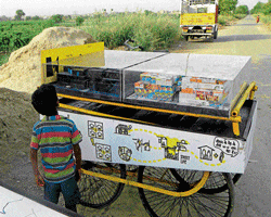 Noble initiative: A child looks at a Life Street Model made by DELHi2050.