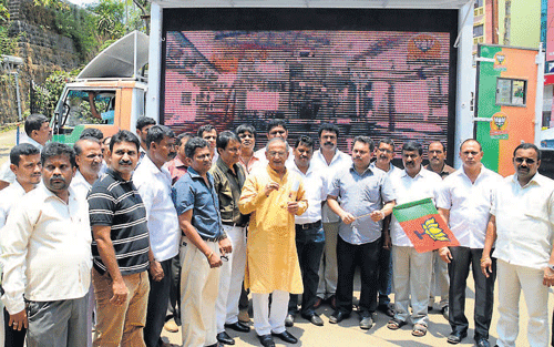 MLC Capt Ganesh Karnik and MLAs from Goa flag off LED projector in a vehicle to highlight the achievement of the BJP government in Mangalore on Saturday. dh photo