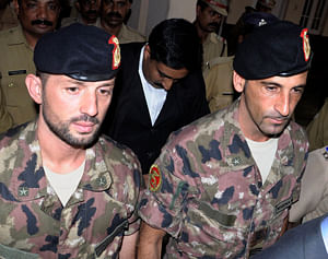 Italian marines Salvatore Girone, left, and Massimilian Latorre arrive at a court in Kollam, India. India's Supreme Court has ruled that an investigative agency will probe a murder case filed against two Italian marines accused of killing two Indian fishermen last year. AP photo.