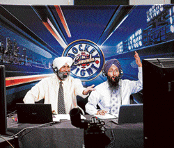 Desi voices: Bhola Chauhan (left) and Harnarayan Singh during a Punjabi broadcast of "Hockey Night in Canada" in Calgary, Canada. NYT