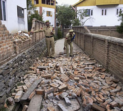 A portion of a hospital wall collapses after an earthquake in Badarwah in Jammu and Kashmir on Wednesday. PTI Photo