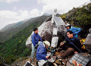 blame game: Osamu Nagafuchi, second from right, an environmental engineer, Kenshi Tetsuka, second from left, chairman of  Yakushima Biodiversity Conserving Conference, and Seiichi Kanetani, the chief researcher of Forestry and Forest Products Research  Institute, collect samples for their atmospheric contamination research on Yakushima Island in Japan. NYT