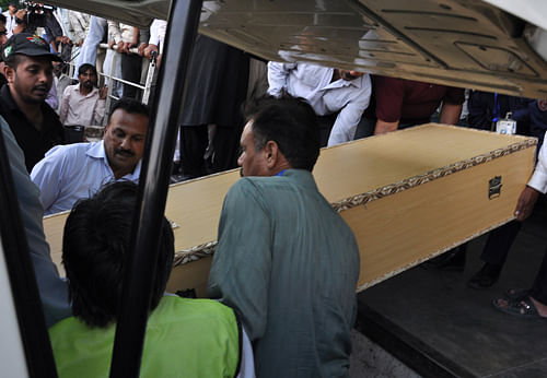 Pakistani cargo staff offload a coffin carrying the body Sarabjit Singh, on its way to India at Lahore airport on Thursday, May 2, 2013 in Pakistan. Indians expressed outrage at the Pakistan government Thursday over the death of Sarabjit,  who had been attacked with a brick by two fellow inmates in a Pakistan prison, a development New Delhi said has damaged relations between the longtime rival nations. AP Photo