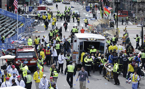 In this April 15, 2013 file photo, medical workers aid injured people at the finish line of the 2013 Boston Marathon following a bomb explosion in Boston, Monday, April 15, 2013. In addition to Tamerlan Tsarnaev, who died after a gunfight with police, and his brother, Dzhokhar Tsarnaev, who was captured and lies in a hospital prison, three more suspects in the bombings were taken into custody, Boston police said Wednesday, May 1, 2013. AP Photo