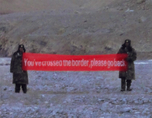 ' YOU'VE CROSSED THE BORDER, PLEASE GO BACK' says a banner held aloft by intruding Chinese troops at Daulat Beg Oldi sector of Ladakh. PTI Photo