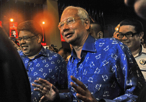 Malaysia's Prime Minister Najib Razak arrives at the United Malays National Organisation (UMNO) headquarters in Kuala Lumpur on May 5, 2013 before the announcement of the election results. Malaysians voted in record numbers in the May 5 general election, with one of the world's longest-serving governments facing a serious threat from an upstart opposition that pledges sweeping reform. AFP PHOTO