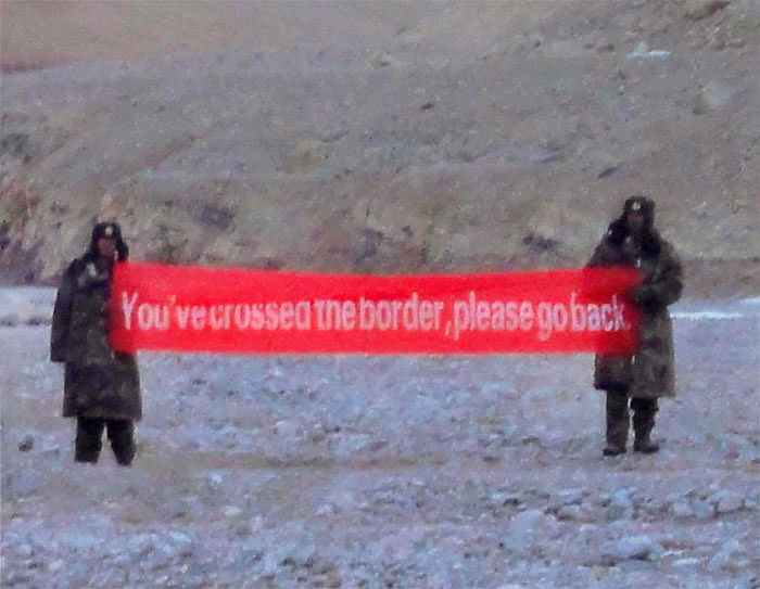 "YOU'VE CROSSED THE BORDER, PLEASE GO BACK' said a banner held aloft by intruding Chinese troops at Daulat Beg Oldi sector of Ladakh. File Image: PTI