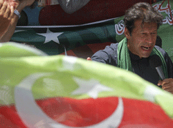 Imran Khan, Pakistani cricketer-turned-politician and chairman of political party Pakistan Tehreek-e-Insaf (PTI), addresses his supporters after his visit to the mausoleum of Mohammad Ali Jinnah, founder and first governor-general of Pakistan, during an election campaign in Karachi May 7, 2013. Pakistan's general election will be held on May 11. REUTERS