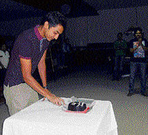 A jubilant Aditya Mehta cuts a cake at the KSBA hall to  celebrate his 147 feat.