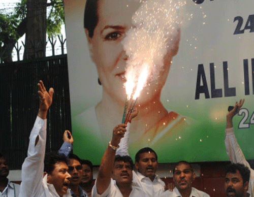 Supporters of the Congress Party celebrate their parties victory, in the Karnataka Assembly elections, in front of party president, Sonia Gandhi, residence in New Delhi on May 8, 2013. Congress defeated the main opposition Bharatiya Janata Party (BJP), as Congress appeared to be well on its way to wresting power on its own after a gap of seven years. AFP PHOTO
