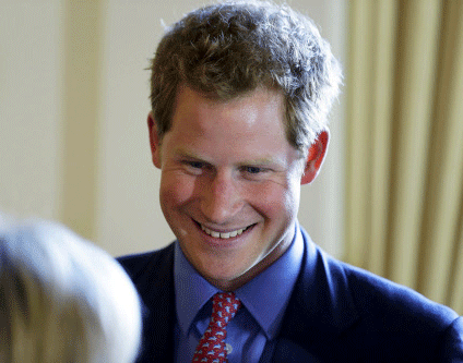 Britain's Prince Harry greets attendees before a reception and dinner at the British Ambassador's residence in Washington May 9, 2013. REUTERS.