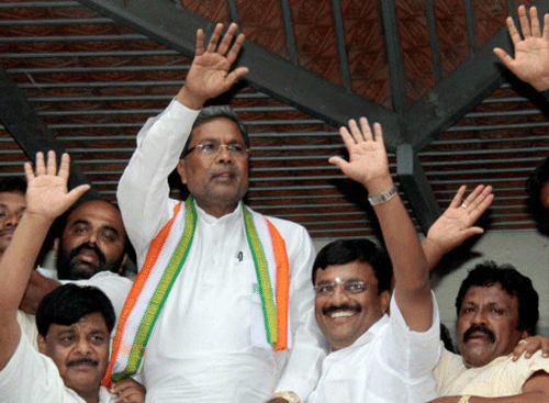 Karnataka Chief Minister-designate Siddaramaiah waves to supporters after he was elected as the Congress Legislative Party leader at KPCC office in Bengaluru. PTI Photo