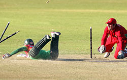 Zimbabwe captain Brendan Taylor (R) attempts a run out of Bangladesh captain Mushfiqur Rahim (L) during the 1st of the two match T20 cricket series between Zimbabwe and Bangladesh on May 11, 2013 at the Queens Sports Club in Bulawayo, Zimbabwe. AFP PHOTO