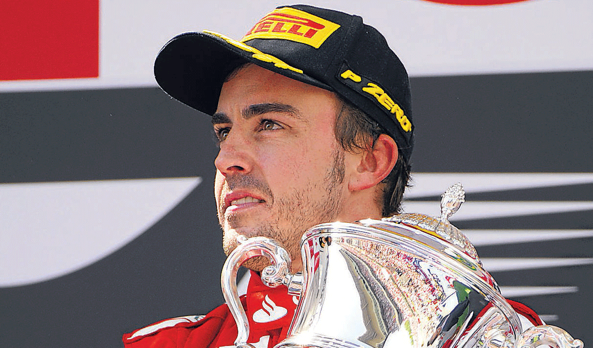 Turning up the heat: Ferrari's Fernando Alonso poses with the trophy after winning the Spanish Grand Prix in Barcelona on Sunday. AP Photo.