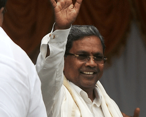 Congress party leader and new Chief Minister of Karnataka K. Siddaramaiah waves to his supporters during his oath-taking ceremony at the Kanteerva Stadium in Bangalore,  Monday, May 13, 2013. Siddaramaiah, 64, administered the oath of office Monday in front of thousands of supporters marking the return of the administration back to the hands of Congress, in the state, after more than 7 years. AP Photo