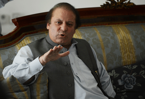 Pakistan's incoming prime minister Nawaz Sharif speaks to journalists at his farm house in Raiwind on the outskirts of Lahore on May 13, 2013. Sharif said that he would be 'very happy' to invite India's Manmohan Singh to his swearing-in ceremony. Nuclear-armed India and Pakistan have fought three wars, two of them over the disputed Himalayan region of Kashmir. AFP PHOTOS