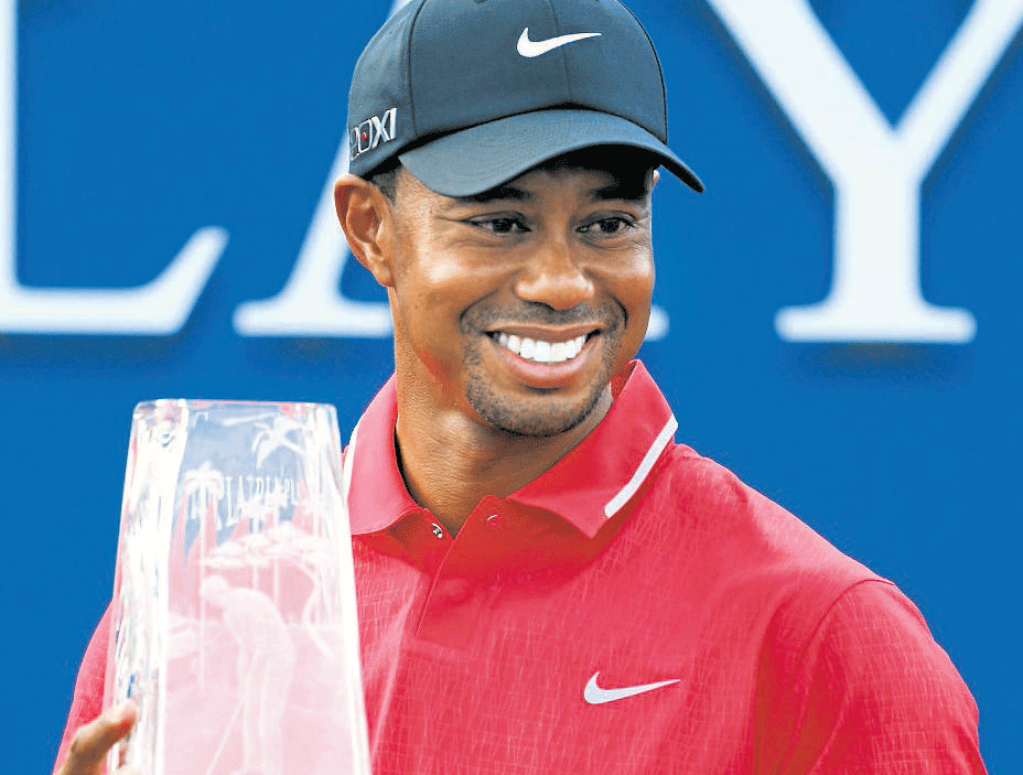Super show: World No 1 Tiger Woods with the Players Championship trophy in Florida on Sunday. AFP Photo.
