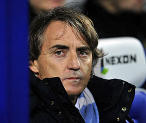 In this file picture taken on January 29, 2013 Manchester City's Italian manager Roberto Mancini looks on before the English Premier League football match between Queens Park Rangers and Manchester City at Loftus Road in London, England . Roberto Mancini was sacked as manager of Manchester City late on May 13, 2013 a year to the day after leading the club to the English Premier League title.AFP PHOTO