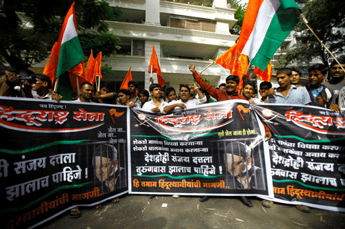 Activists of right-winged Hindu Rashtra Sena shout slogans during a protest outside the residence of Bollywood star Sanjay Dutt, seen in banner, in Mumbai Wednesday, May 15, 2013. The activists demanded Dutt be hanged for the 1993 Mumbai terror attack that killed 257 people. Dutt has been sentenced to five years in prison for illegal possession of weapons supplied by Muslim mafia bosses linked to the attack. AP Photo
