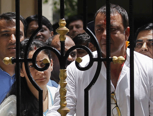 Bollywood actor Sanjay Dutt looks out from his house as he leaves to surrender at a court, in Mumbai May 16, 2013. Actor Sanjay Dutt is set to go to prison today after India's Supreme Court last week rejected a petition seeking a review of his earlier jail sentence for firearms offences during the Mumbai blasts 20 years ago. REUTERS