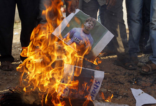 Demonstrators burn a poster of  Sreesanth during a protest in  Ahmedabad on Thursday. REUTERS