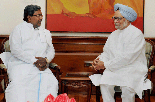 Prime Minister Manmohan Singh with Karnataka Chief Minister K Siddaramaiah in New Delhi on Thursday. PTI Photo