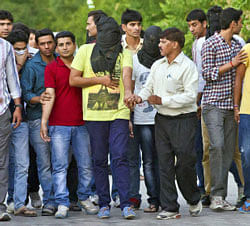 Indian cricketers and bookies, some with faces covered, are marched to a court after being arrested for spot fixing in cricket, in New Delhi, India, Thursday, May 16, 2013. Police arrested Indian cricketers Shanthakumaran Sreesanth, Ankeet Chavan and Ajit Chandila over allegations of spot-fixing, involving performing in a pre-determined way at set times for the benefit of gamblers, during a domestic Twenty20 game. (AP Photo)